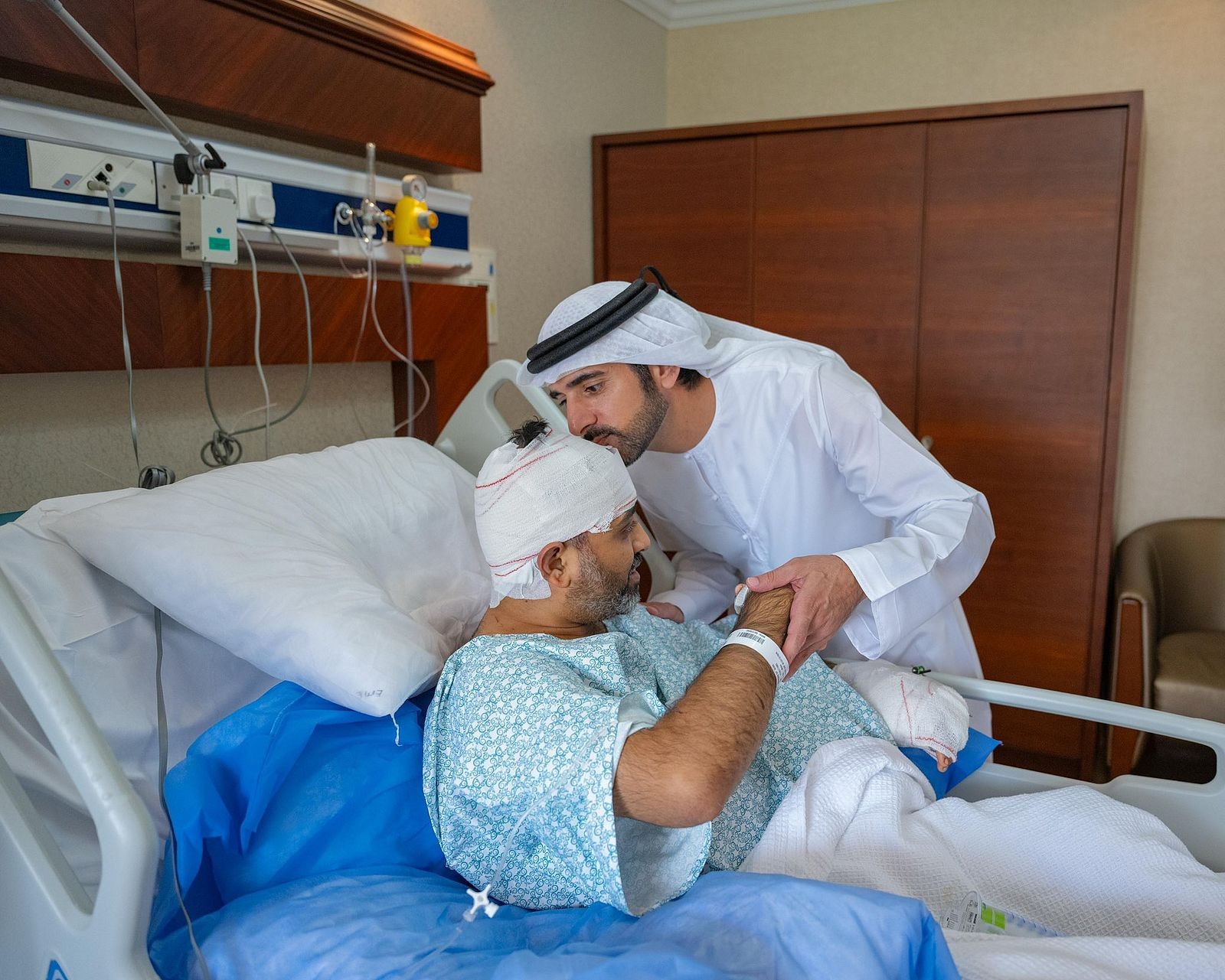 His Highness Sheikh Hamdan bin Mohammed bin Rashid Al Maktoum greets Captain Smit Machchhar at his hospital bedside